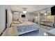 Main bedroom with a large bed and mirrored closet doors at 10114 Chimney Hill Ct, Tampa, FL 33615