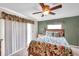 Bedroom with leafy patterned bedding and private balcony access at 1050 Starkey Rd # 2701, Largo, FL 33771