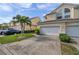 Townhome exterior featuring double garage and manicured landscaping at 1050 Starkey Rd # 2701, Largo, FL 33771