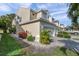 Tan townhome with double garage and side yard landscaping at 1050 Starkey Rd # 2701, Largo, FL 33771