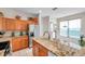 Well-equipped kitchen with granite countertops and wood cabinets at 1050 Starkey Rd # 2701, Largo, FL 33771