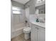 Updated bathroom with white vanity and tub shower combo at 10926 N Lantana Ave, Tampa, FL 33612