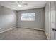 Simple bedroom with neutral wall paint, ceiling fan, and carpet at 10926 N Lantana Ave, Tampa, FL 33612