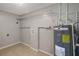 Functional laundry room with shelving and water heater at 10926 N Lantana Ave, Tampa, FL 33612