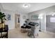 Bright living room with gray couch, patterned chair, and tile floors at 10926 N Lantana Ave, Tampa, FL 33612