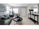 Living area features a gray couch, chair, and console table at 10926 N Lantana Ave, Tampa, FL 33612