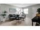 Living room features gray couch and chair, coffee table, and tile floors at 10926 N Lantana Ave, Tampa, FL 33612