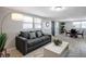 Bright living room features a comfy sofa and coffee table, with adjacent dining area at 10926 N Lantana Ave, Tampa, FL 33612