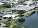 Aerial view of community clubhouse, pool, and waterfront at 1100 Belcher S Rd # 190, Largo, FL 33771