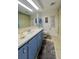 Clean bathroom with blue vanity, shower/tub combo, and updated fixtures at 1100 Belcher S Rd # 190, Largo, FL 33771