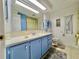 Updated bathroom with a blue vanity and shower/tub combo at 1100 Belcher S Rd # 190, Largo, FL 33771