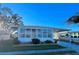White single-wide manufactured home with carport and landscaped yard at 1100 Belcher S Rd # 190, Largo, FL 33771