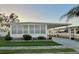 White single-wide manufactured home with carport and landscaping at 1100 Belcher S Rd # 190, Largo, FL 33771