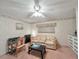 Cozy guest room features a comfy sofa, a convenient workspace, and ceiling fan at 1100 Belcher S Rd # 190, Largo, FL 33771
