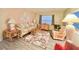 Living room features a floral sofa and comfy wicker chairs at 1100 Belcher S Rd # 190, Largo, FL 33771