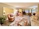 Living room with wood-look floors, wicker furniture, and a bookcase at 1100 Belcher S Rd # 190, Largo, FL 33771