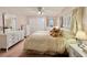 Main bedroom featuring a large bed, dresser, and soft color scheme at 1100 Belcher S Rd # 190, Largo, FL 33771
