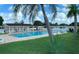 Community pool with lounge chairs and surrounding landscaping at 1100 Belcher S Rd # 190, Largo, FL 33771