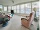 Bright sunroom with multiple windows, comfortable seating, and a TV at 1100 Belcher S Rd # 190, Largo, FL 33771