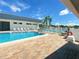 Community pool with plenty of lounge chairs at 1100 Belcher S Rd # 190, Largo, FL 33771