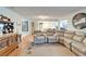 Living room with sectional sofa, hardwood floors, and a view of the kitchen at 1111 Harefield Cir # 62, Sun City Center, FL 33573