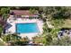 Aerial view of community pool with surrounding lounge chairs and landscaping at 1111 Harefield Cir # 62, Sun City Center, FL 33573