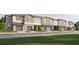 Modern townhome community with attached garages and landscaped lawns at 11176 Wishing Cloud Rd, Land O Lakes, FL 34638