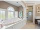 Elegant bathroom featuring a luxurious soaking tub, separate glass-enclosed shower, and stylish fixtures at 1124 Seville Ne Ln, St Petersburg, FL 33704