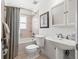 Bright bathroom featuring a shower-tub combo, pedestal sink, and tiled floor at 1124 Seville Ne Ln, St Petersburg, FL 33704