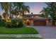 Stunning two-story home with a brick driveway and lush landscaping at 1124 Seville Ne Ln, St Petersburg, FL 33704