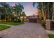 Two-story home with a brick driveway and landscaping at 1124 Seville Ne Ln, St Petersburg, FL 33704