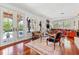 Living room with hardwood floors, French doors opening to the pool area at 1124 Seville Ne Ln, St Petersburg, FL 33704