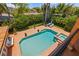 An aerial view of a backyard pool and hot tub, surrounded by lush tropical landscaping at 1124 Seville Ne Ln, St Petersburg, FL 33704