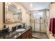 Updated bathroom with granite vanity and walk-in shower at 12002 Washington St, Seffner, FL 33584