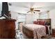 Bright bedroom featuring a ceiling fan and wood floors at 12002 Washington St, Seffner, FL 33584