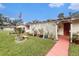 Landscaped front yard with walkway to charming ranch-style home at 12002 Washington St, Seffner, FL 33584