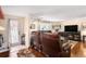 Spacious living room with hardwood floors, leather furniture, and fireplace at 12002 Washington St, Seffner, FL 33584