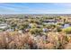 Aerial view of home situated in a residential neighborhood near a lake at 1291 Golden Oak Dr, Tarpon Springs, FL 34689