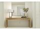 Light and airy entryway with a wood console table, mirror, and stylish decor at 13021 Calcite Blue Ave, Wimauma, FL 33598