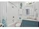 Modern bathroom with a walk-in shower and blue vanity at 145 Brightwater Dr # 2, Clearwater, FL 33767