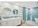 Elegant bathroom with double vanity, glass shower, and soaking tub at 145 Brightwater Dr # 2, Clearwater, FL 33767