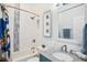 Bathroom with tub shower combo, gray vanity, and decorative accents at 145 Brightwater Dr # 2, Clearwater, FL 33767