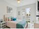 Bedroom with queen bed, balcony access, and light decor at 145 Brightwater Dr # 2, Clearwater, FL 33767