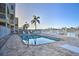 Community pool with lounge chairs and waterfront views at 145 Brightwater Dr # 2, Clearwater Beach, FL 33767