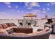 Entertaining rooftop terrace with fire pit, grill, and comfortable seating at 145 Brightwater Dr # 2, Clearwater, FL 33767