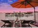 Relaxing rooftop terrace with city views, lounge chairs, and umbrella at 145 Brightwater Dr # 2, Clearwater, FL 33767