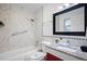 Modern bathroom with granite countertop and marble shower surround at 1571 Jeffords St, Clearwater, FL 33756