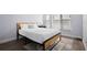 Cozy bedroom with a full-size bed and wood-look flooring at 1571 Jeffords St, Clearwater, FL 33756