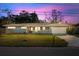 Updated one-story home with a gray exterior, new landscaping, and a two-car garage at 1571 Jeffords St, Clearwater, FL 33756
