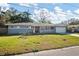 Single-story home with gray exterior, attached garage, and a well-maintained lawn at 1571 Jeffords St, Clearwater, FL 33756